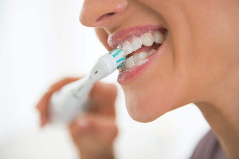Woman Brushing Teeth Closeup