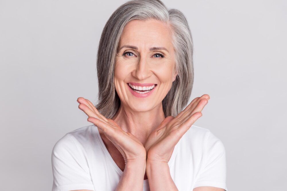 Middle age woman hands up with smile