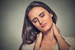 Woman holding her neck in discomfort