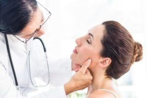 Doctor examining a womans face
