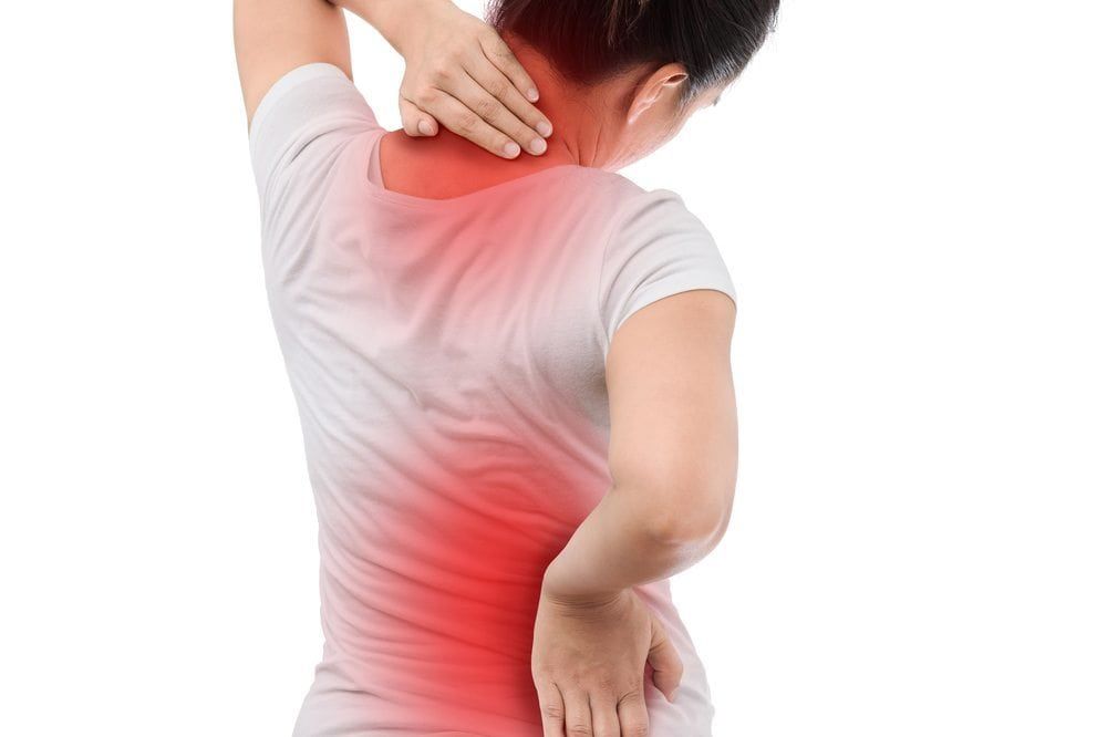 Woman experiencing back and neck pain from Systemic Lupus Erythematosus