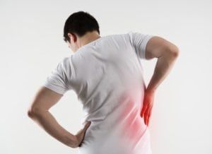 Man in discomfort holding his right side due to kidney pain