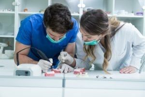 2 prosthodontists working on dentures