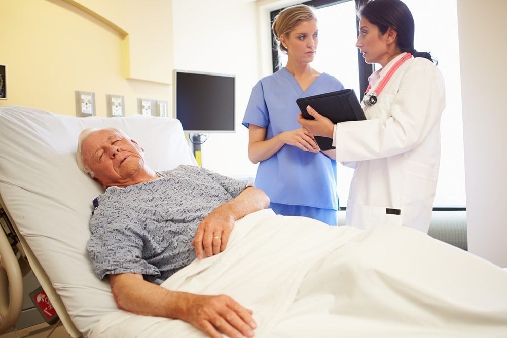 Doctors studying a senior patients sleep patterns